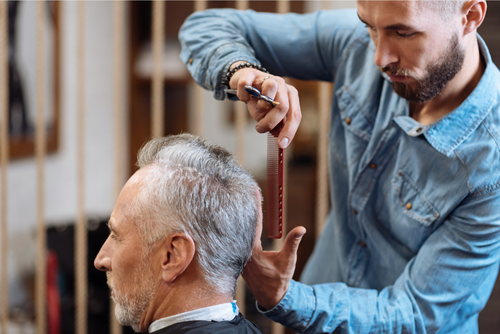 Senior_man_having_on-site_haircut_in_senior_living_by_mobile_barber_1671557832.png